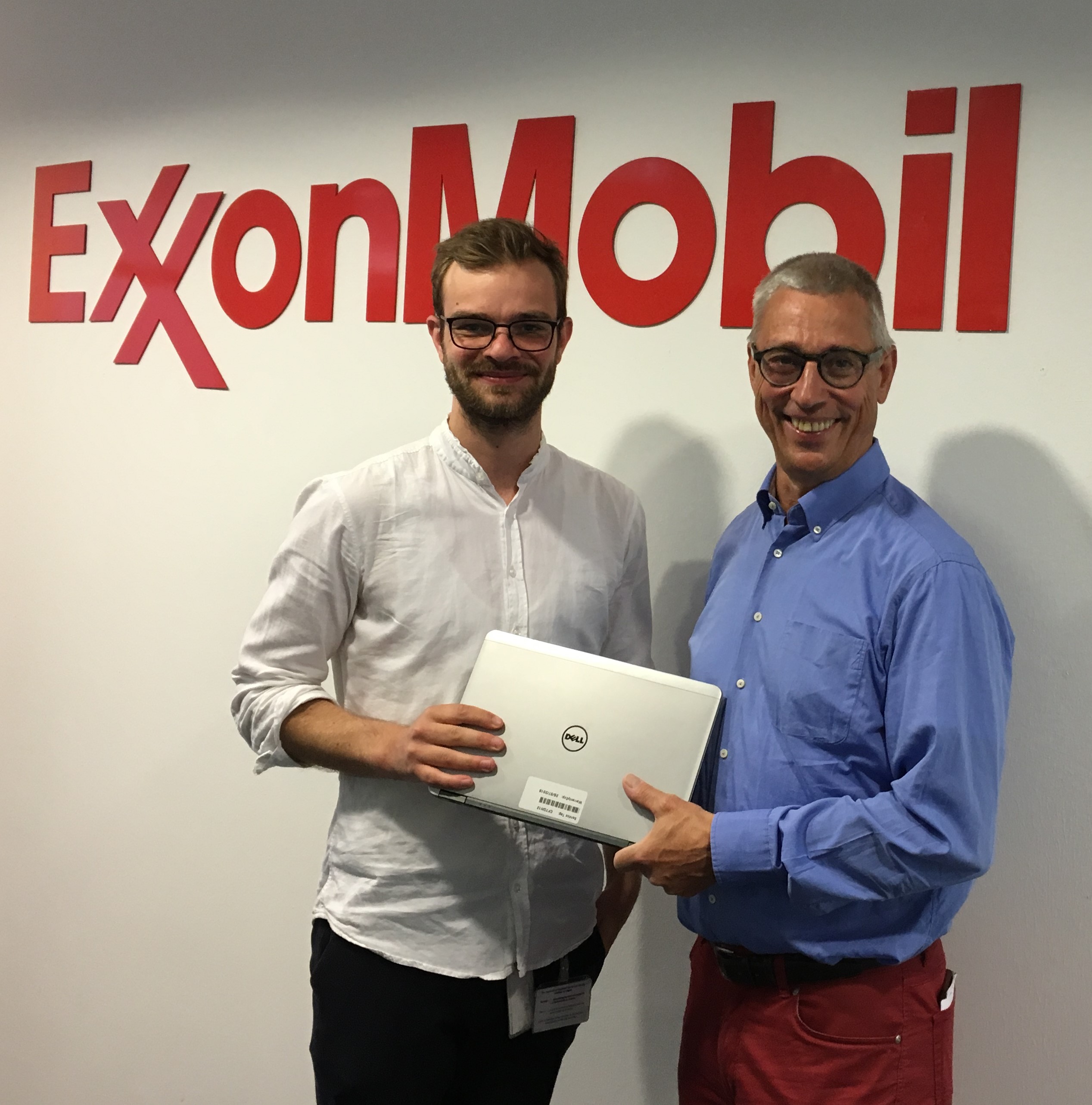 Image Foto  Jannik Ludwig, IT-Mitarbeiter bei ExxonMobil (links), bergibt einen symbolischen Laptop an Jrgen Glckler von der Flchtlingsinitiative Willkommen in Schildgen